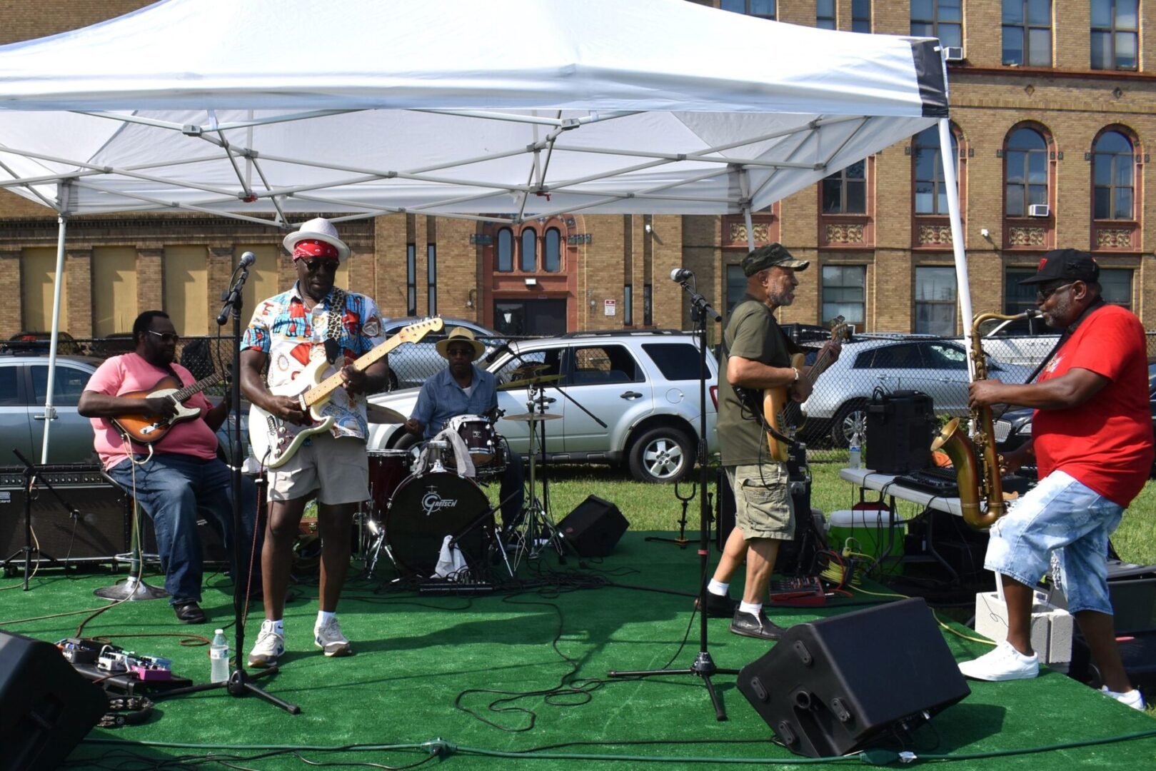 Outdoor band performance with energetic musicians and audience.