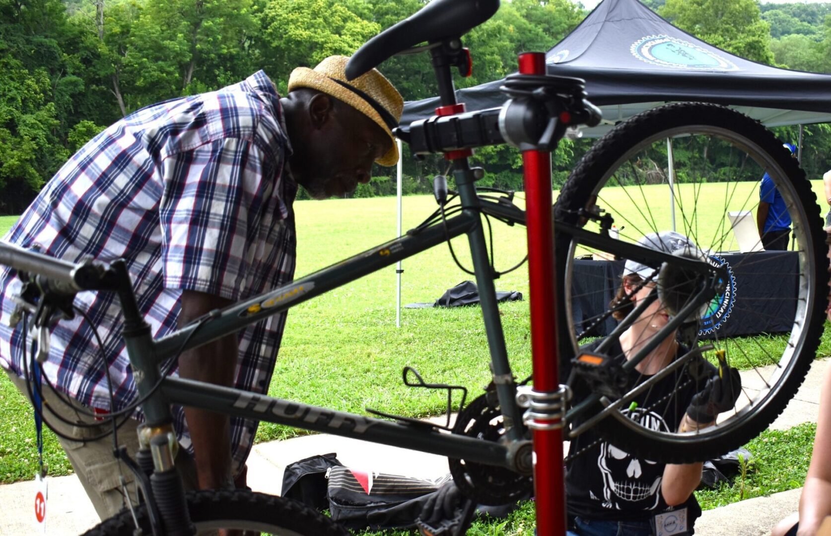Man repairing bicycle outdoors