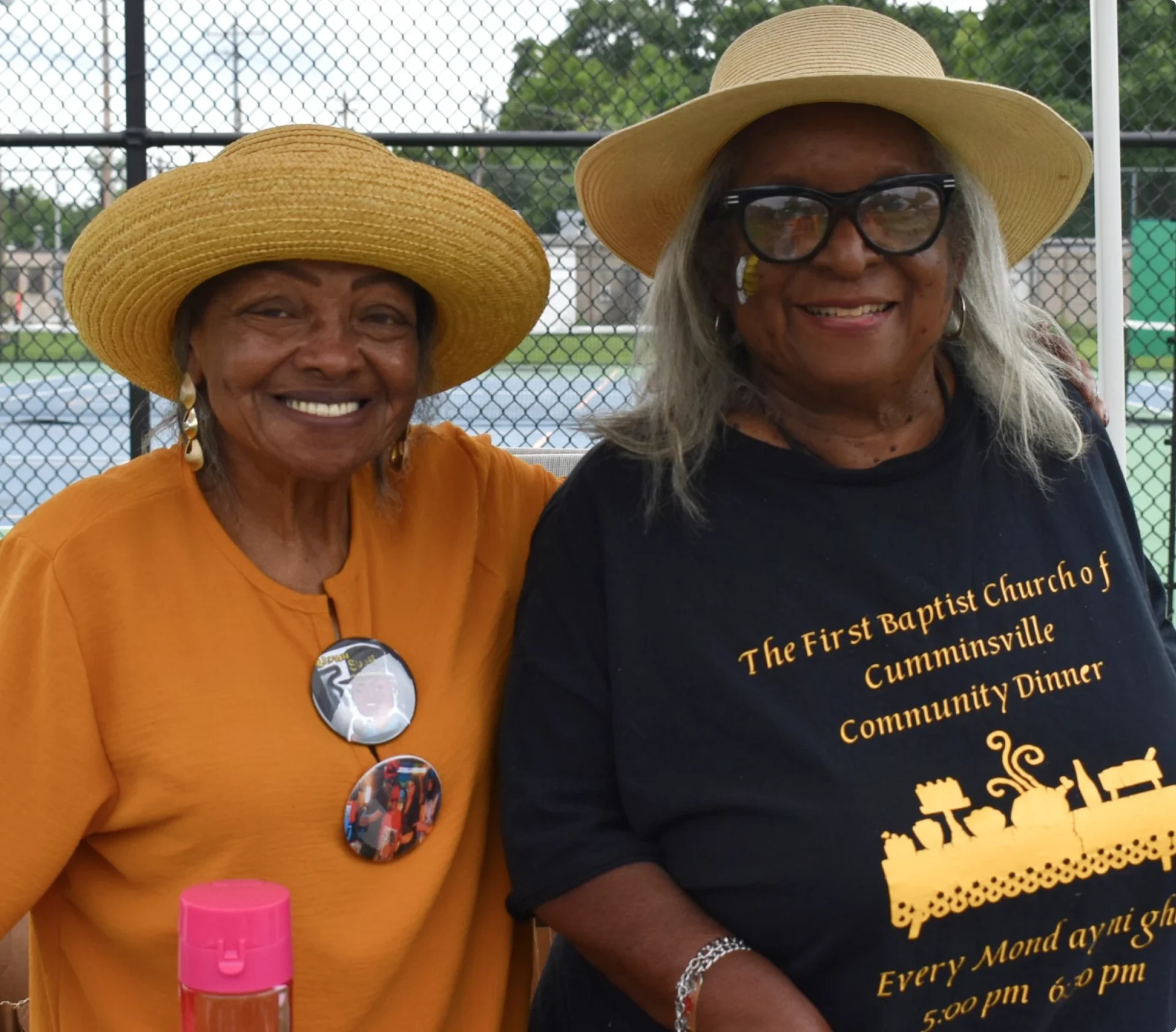 Women at community event with hats